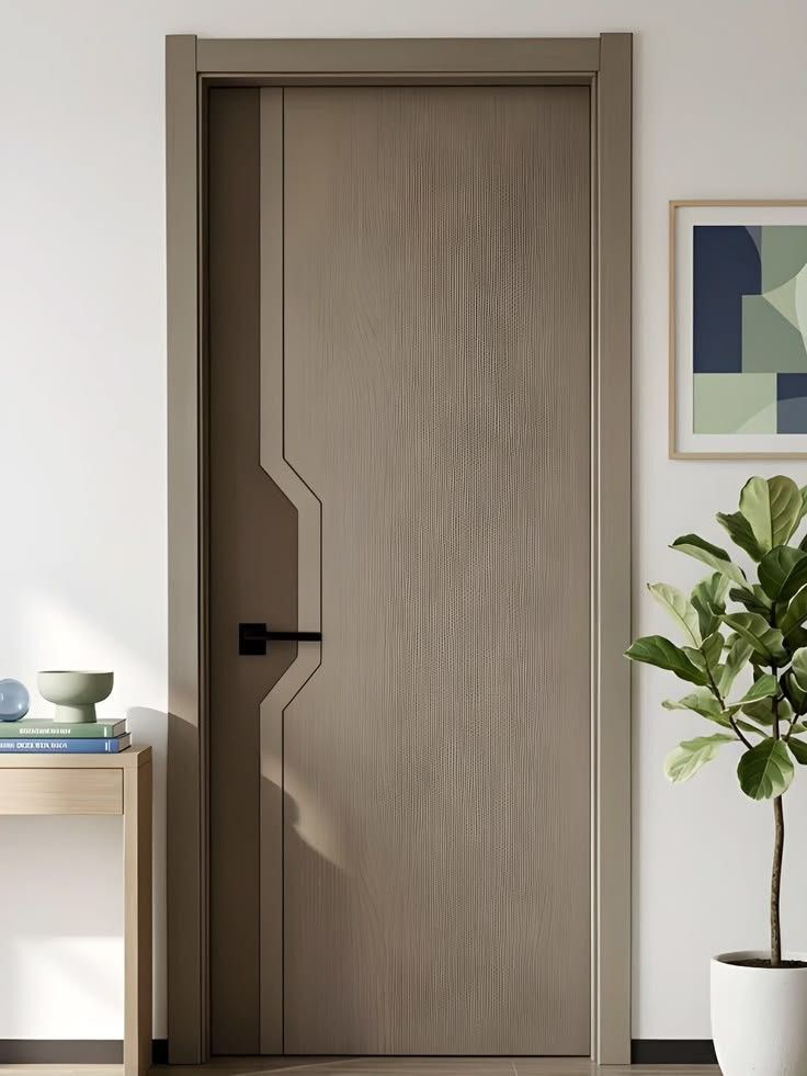 Taupe engineer door with a curved full-height groove and black lever handle